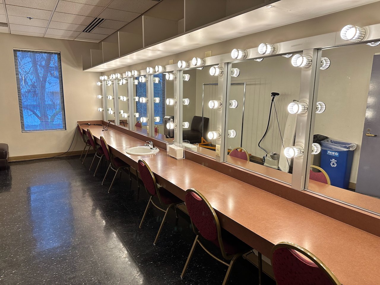 Backstage dressing room with lighted mirrors